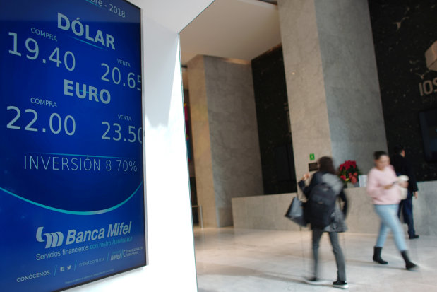 International Business Euro Set For Gest Daily Gain Vs Pound In People Walk Past A Board Displaying The Exchange Rates Of Mexican Peso Against U S Dollar And Euro At Bank In Mexico City December 17 2018