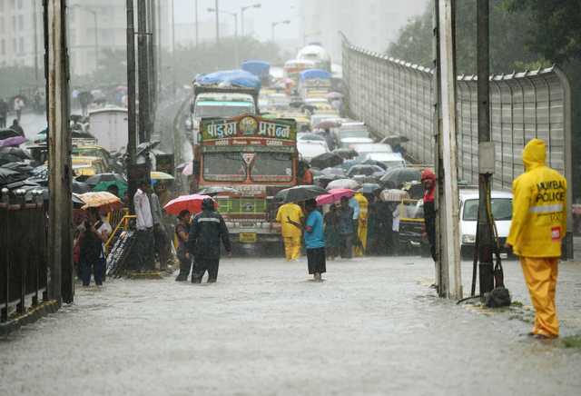 World News: In Pictures: Traffic gridlocked as monsoon rains flood ...