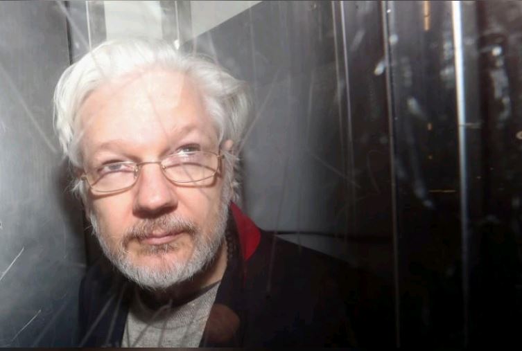 with his legal team to discuss his fight against extradition to