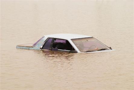 Mother and child die after car swept away during...
