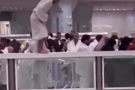 Pilgrim faces action after praying on a railing...