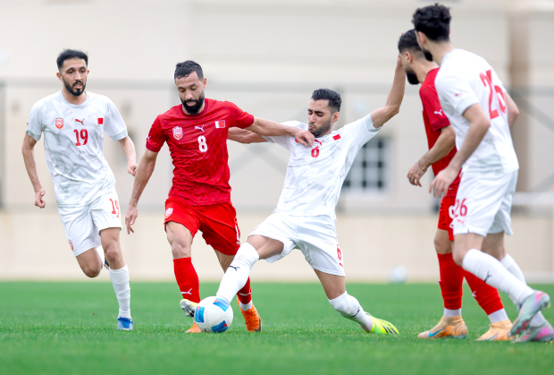 Bahrain’s Mohammed Jassim Marhoon (8), battles to keep possession with teammate Abbas Al Asfoor (6), amongst other teammates