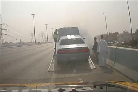 Kuwait traffic patrol officer prevents vehicle...