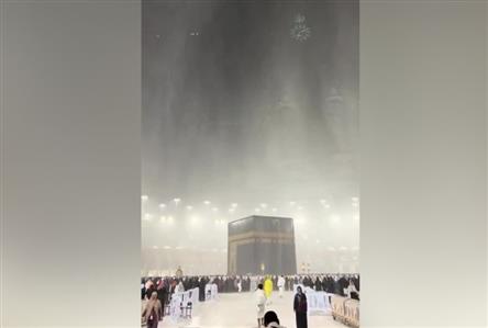 Worshippers continue prayers as rain lashes...