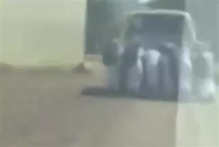 Omani school children push broken-down bus to...